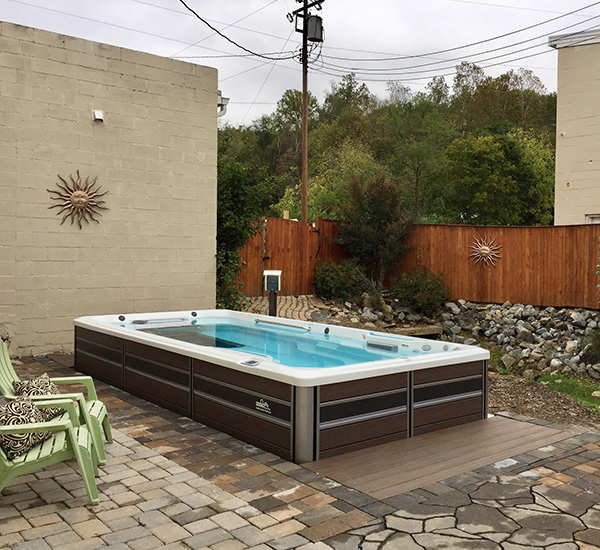 In-ground swim spa installation in back patio